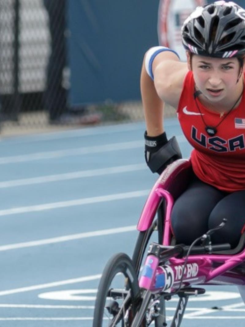 Woman in racing wheelchair