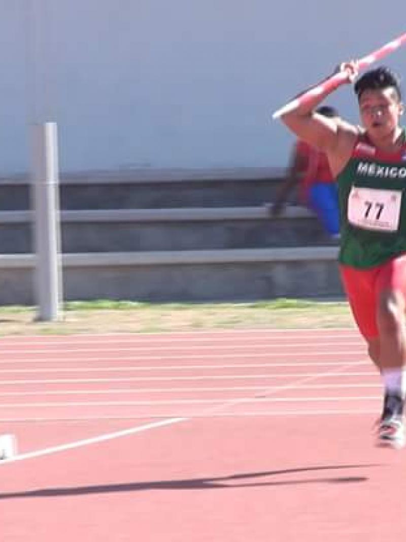 A young boy throwing a javelin
