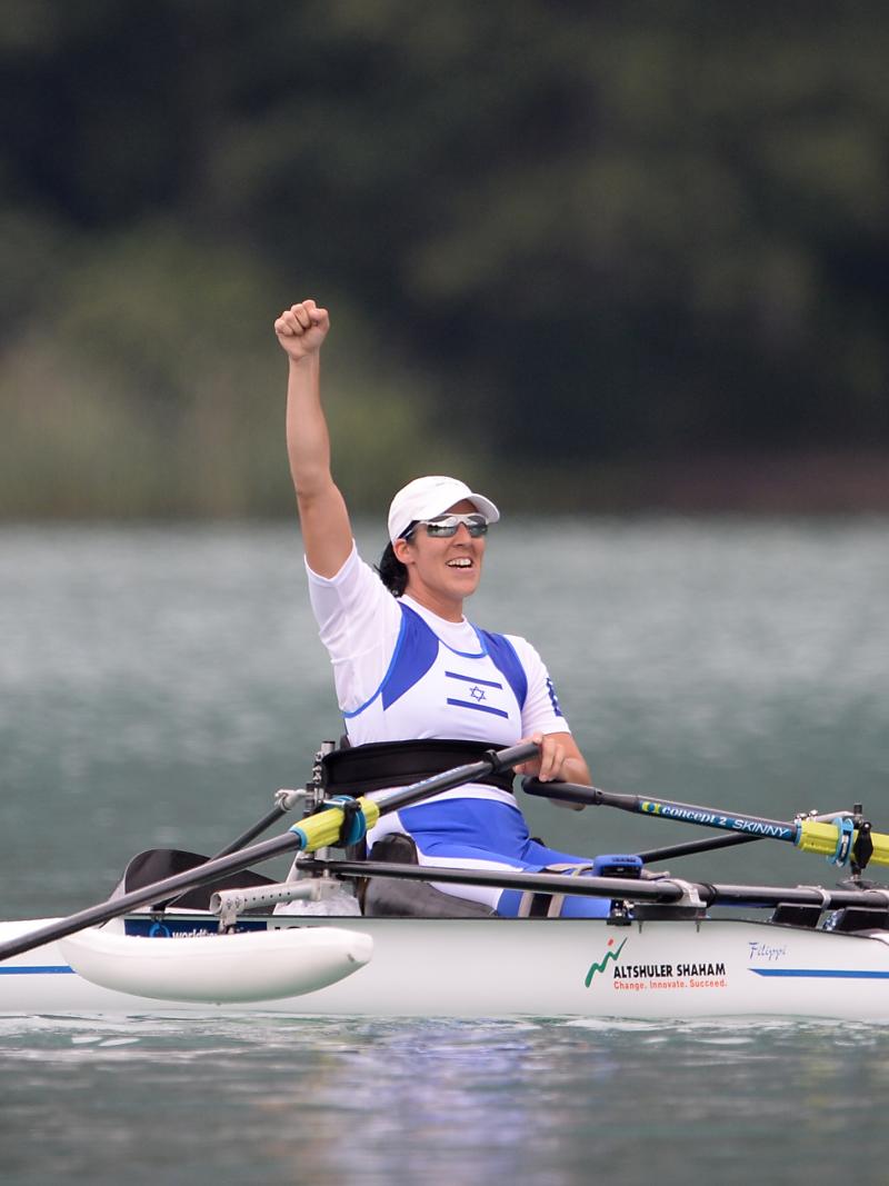 Woman in roing boat celebrates