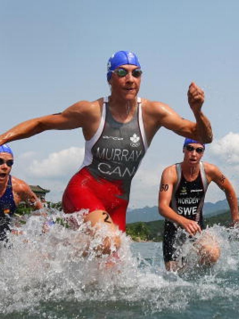 Women in swim suite leaving the water.