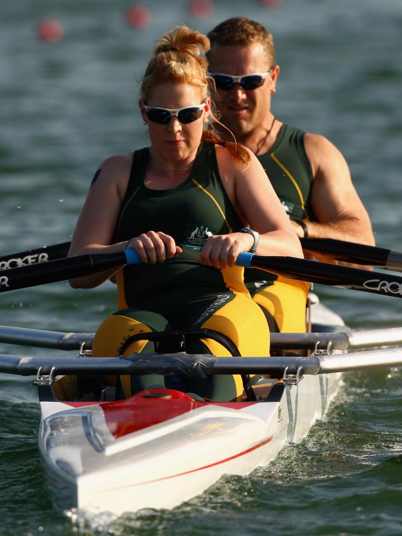 Man male and female rower on boat in the water.