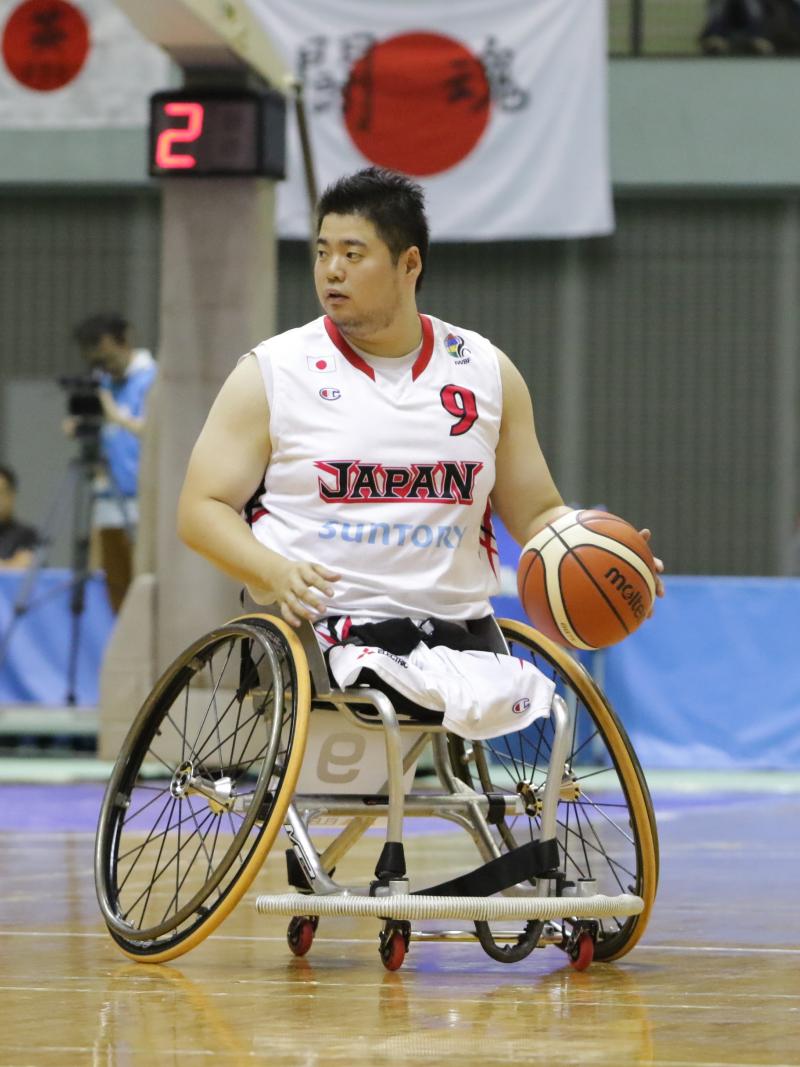 Man in wheelchair chases basketball