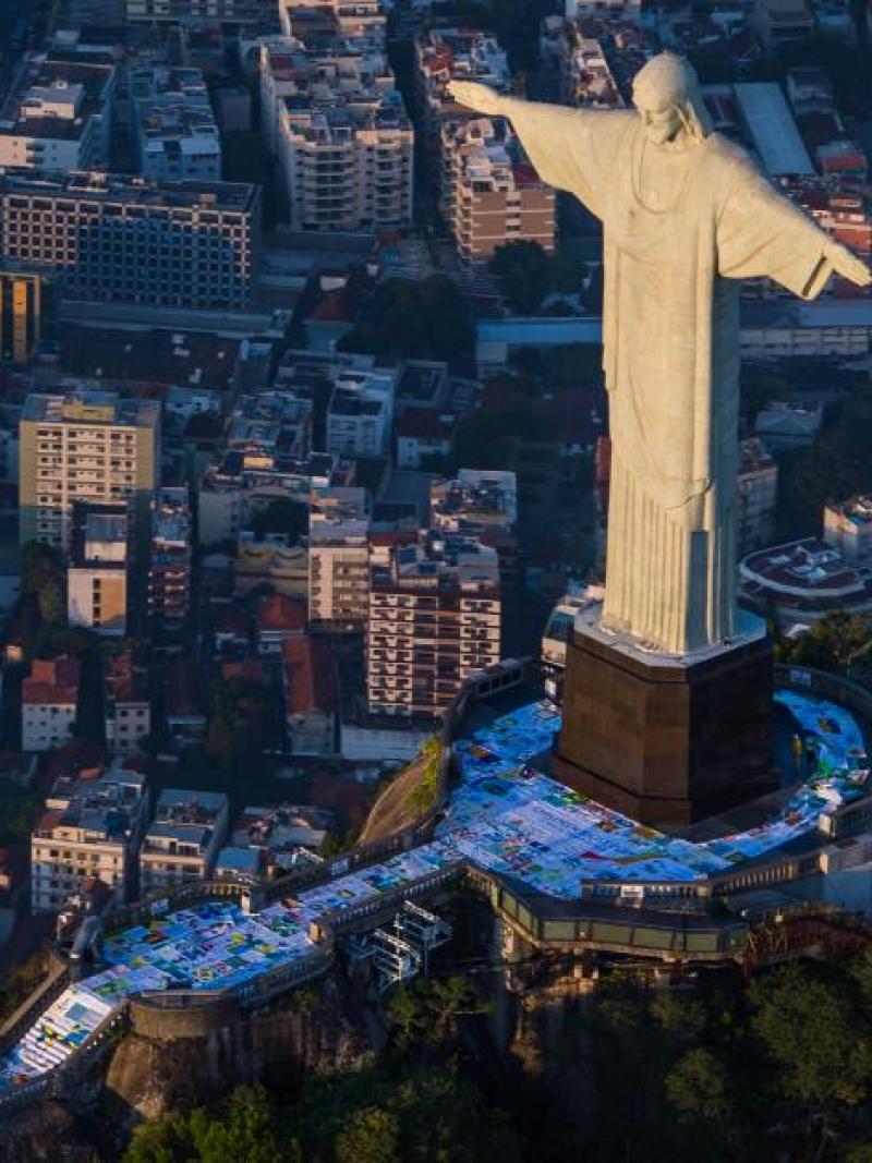 The giant flag was divided into seven pieces to be transported up to the Christ statue 
