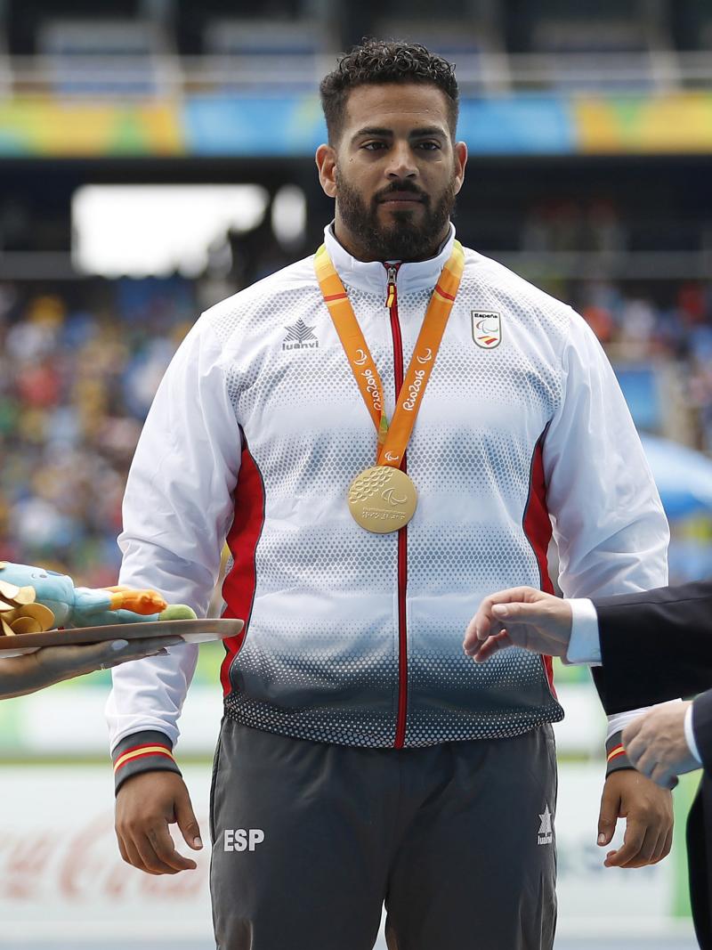 Man on podium receives medal