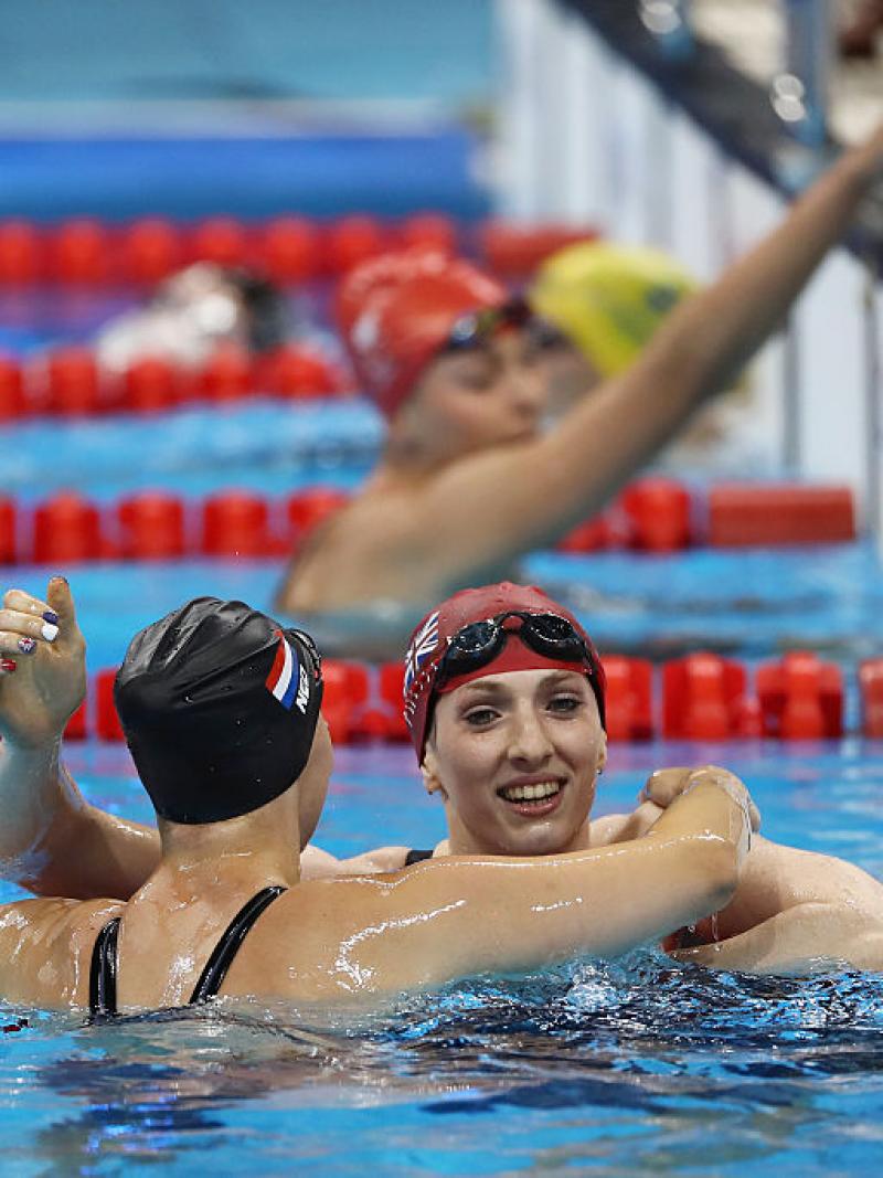 Bethany Firth (R) of Great Britain is embraced by Marlou van der Kulk (L) of the Netherlands after winning the gold medal in the Women's 100m Backstroke