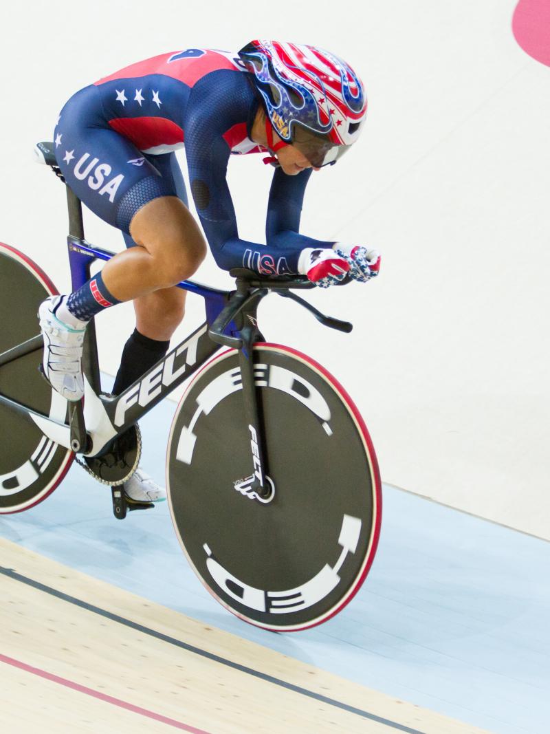 Woman on bike in a velodrome