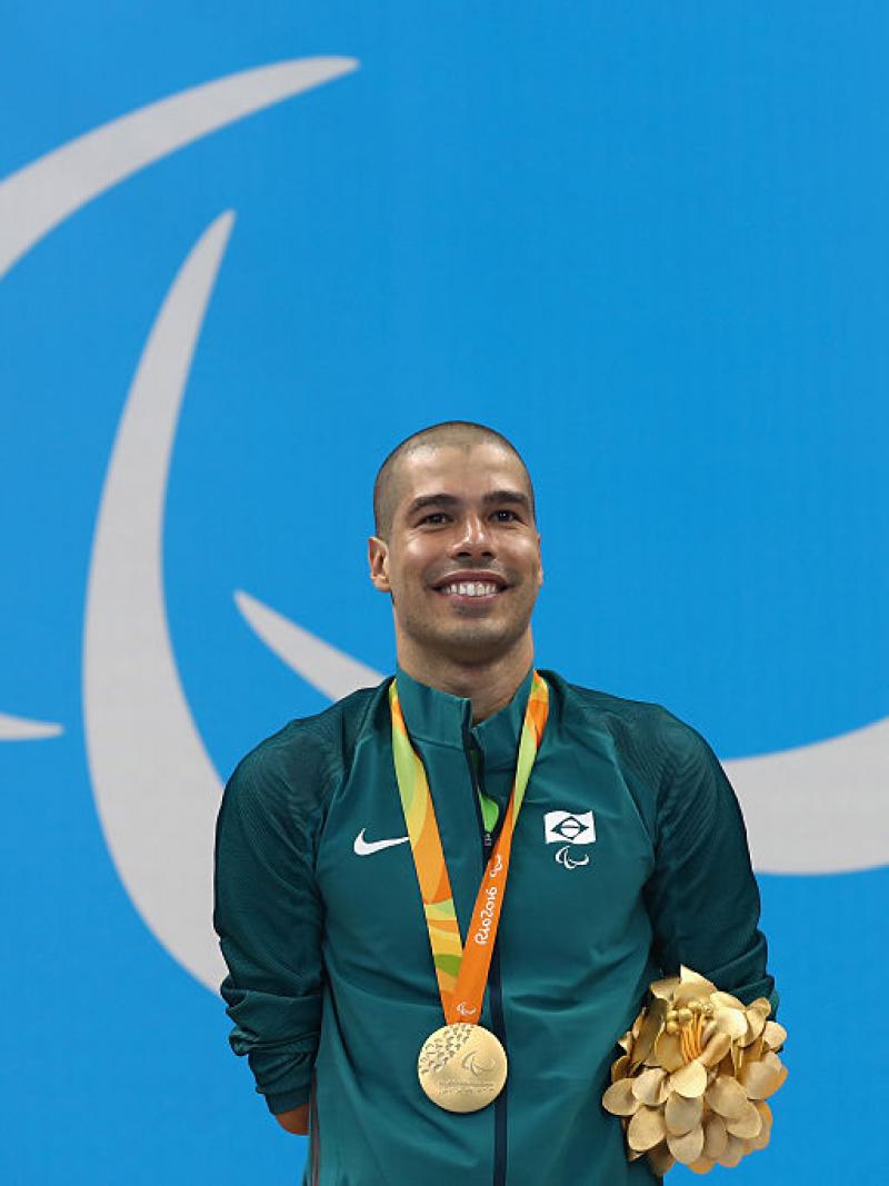 Gold medalist Daniel Dias of Brazil celebrates on the podium at the medal ceremony for the Men's 200m Freestyle - S5 Final on day 1 of the Rio 2016 Paralympic Games