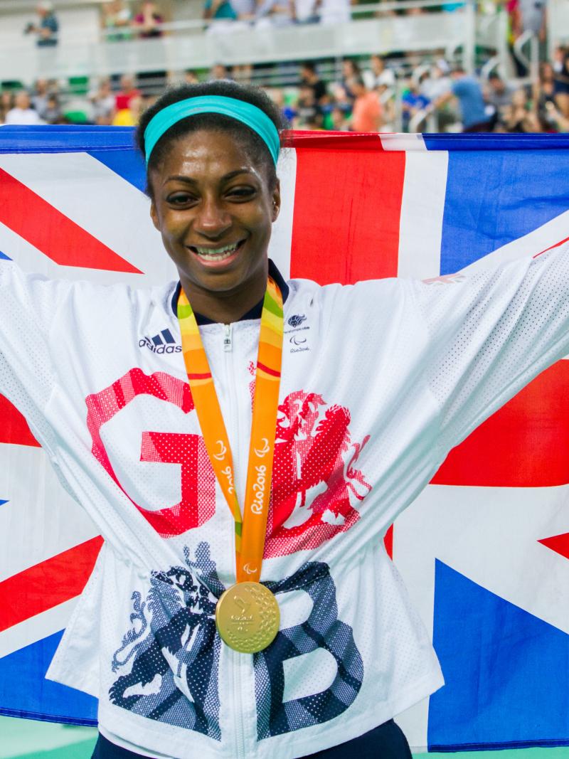 Woman with British flag and medal around her neck