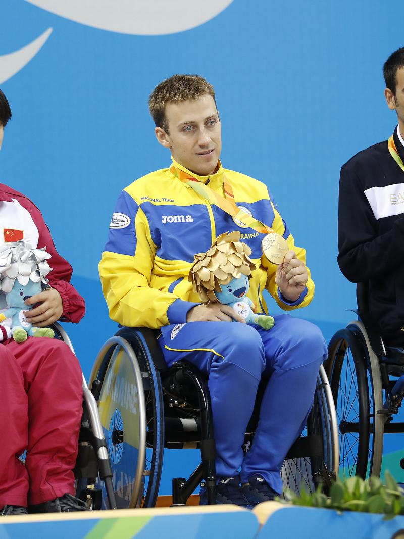 Three medallists in wheelchairs on the podium