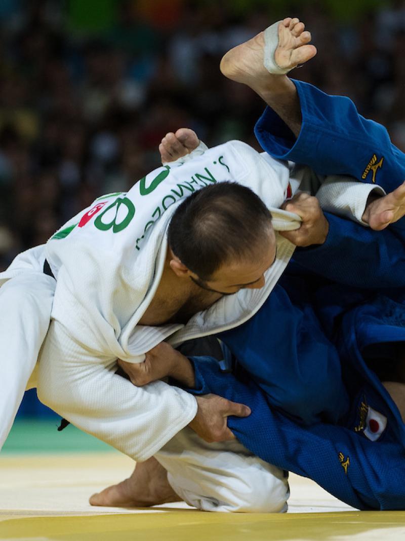 Sherzod Namozov UZB (white) battles with Makoto Hirose JPN during the Men -60 kg Gold Medal bout