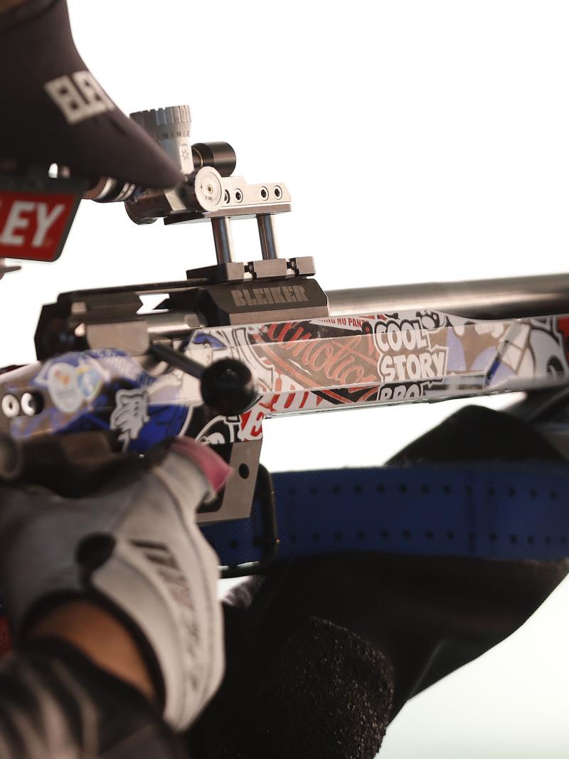 A shooting para athlete holding a rifle.