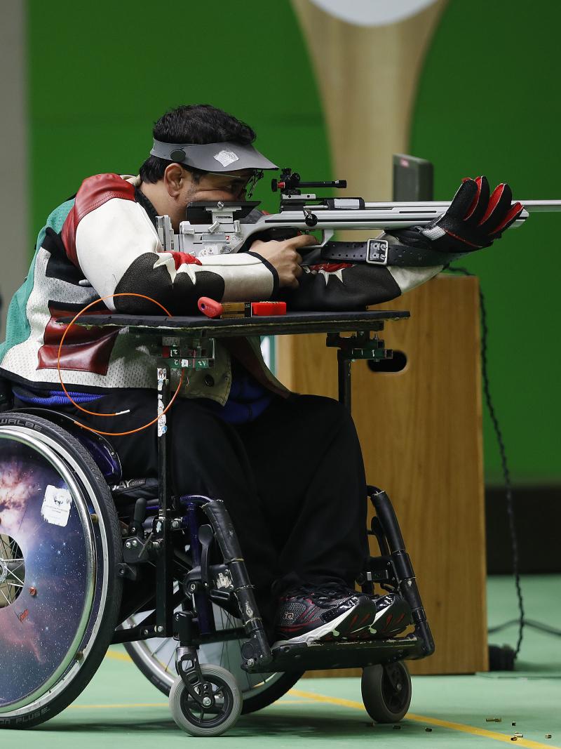 Man in wheelchair in a shooting range, targeting