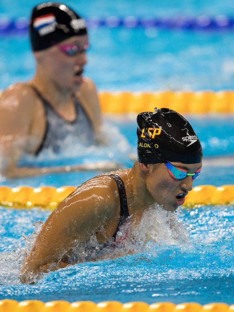 Heads of two swimmers above the water