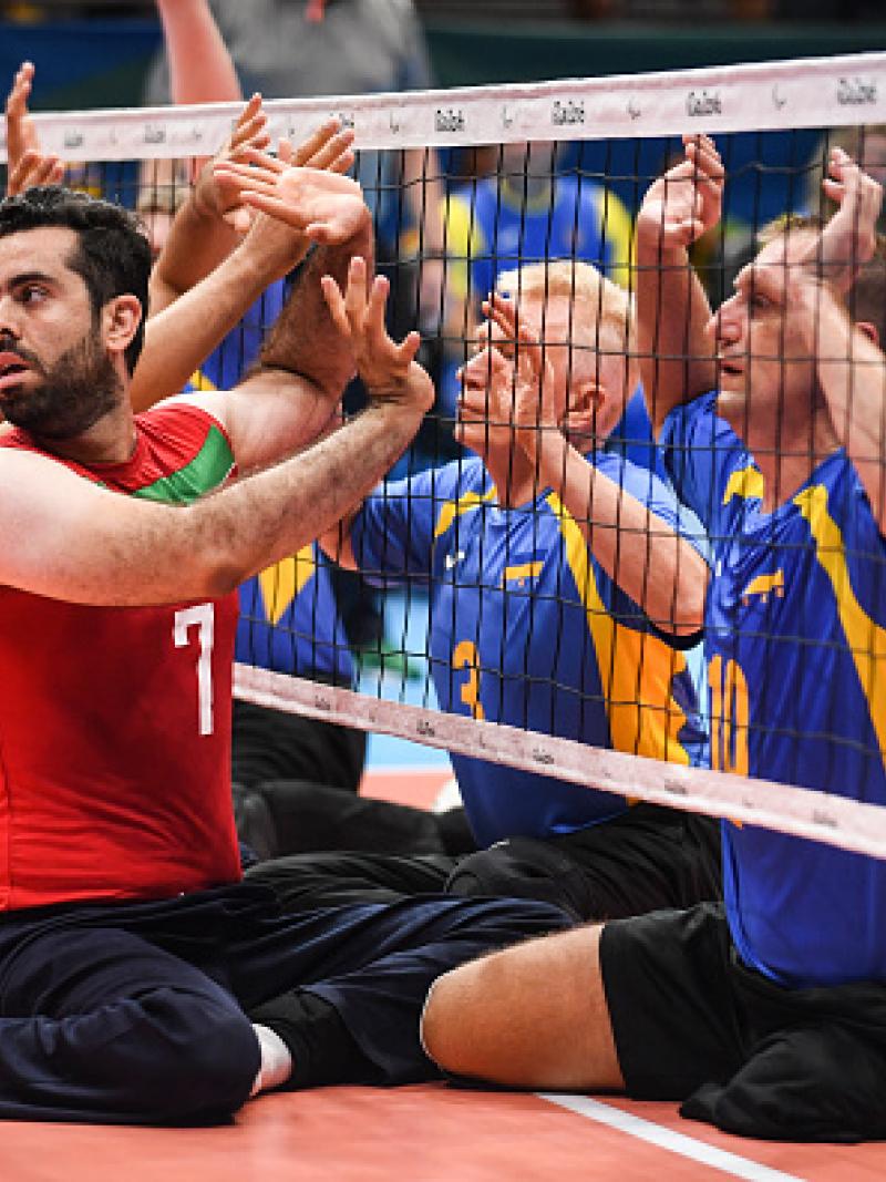 Sadegh Bigdeli of Iran, Petro Ostrynskyi and Sergii Shevchenko of Ukraine compete during Mens Sitting Volleyball match between Iran and Ukraine at the Rio 2016 Paralympic Games.