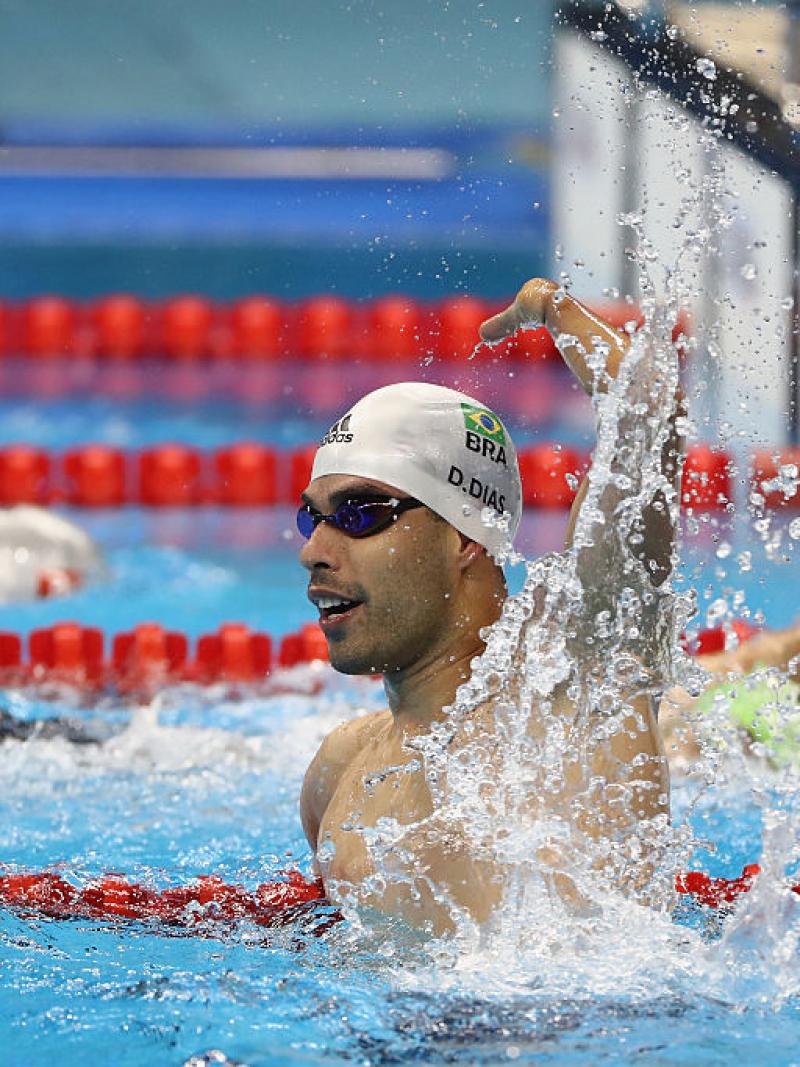 A swimmer celebrates winning gold