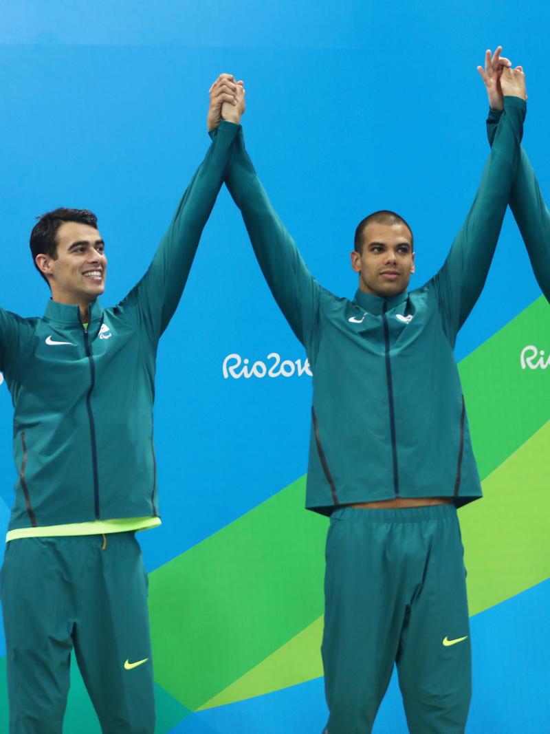 Four Brazilian swimmers on a podium celebrating