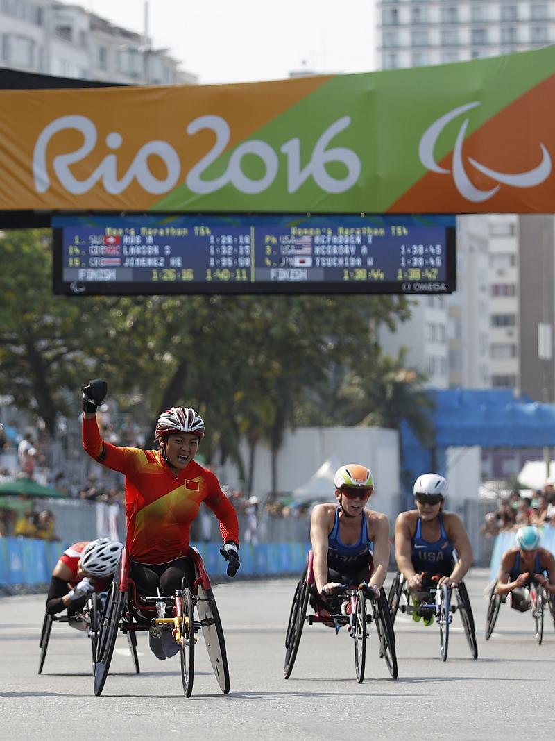 Lihong Zou of China celebrates as she win Gold Medal ahead of Tatyana McFadden USA in Silver Medal position in the Women's T54 Marathon at the Rio 2016 Paralympic Games.