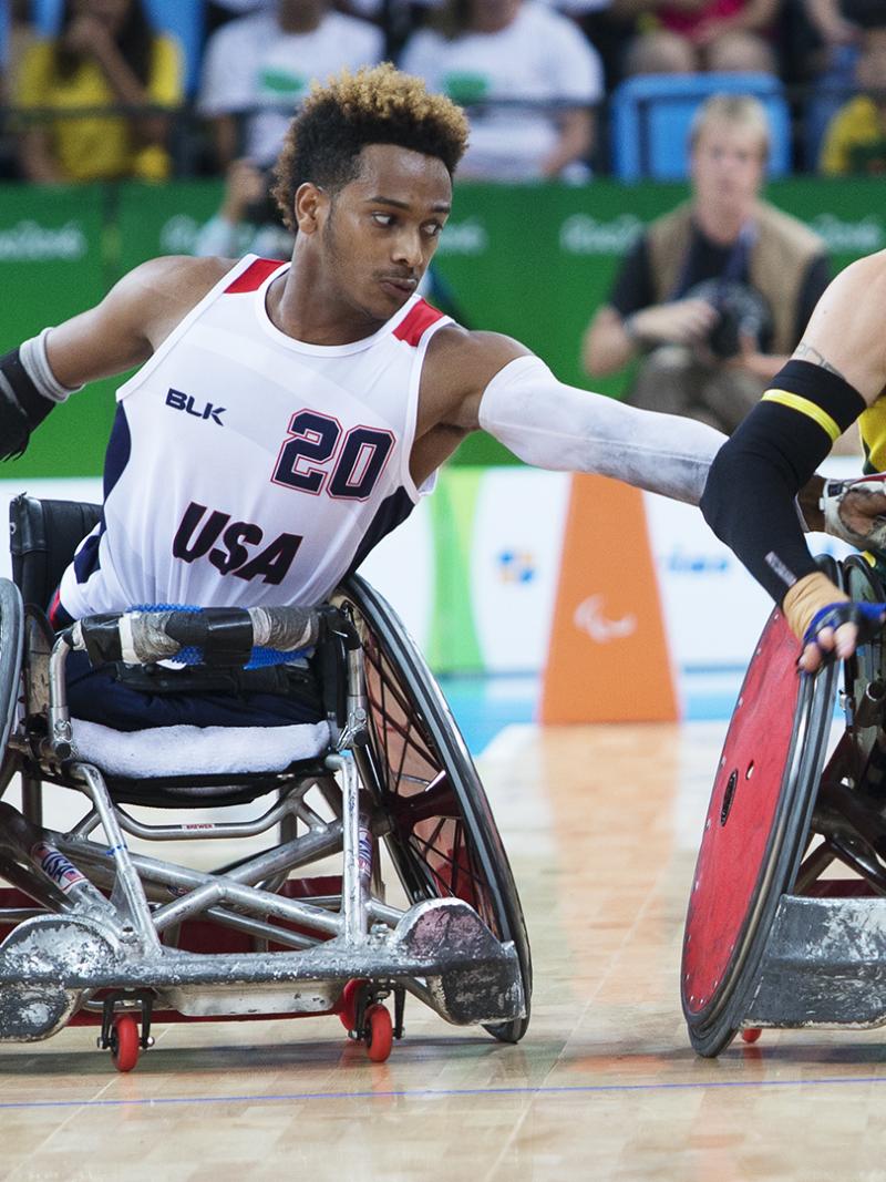 Australia's Chris Bond pushes down the court as USA's Josh Brewer reaches for the ball