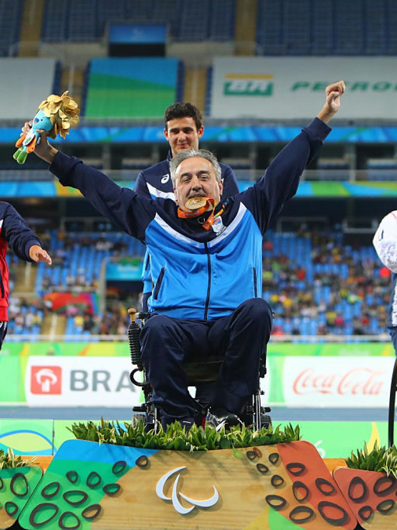 Gold medalist Zeljko Dimitrijevic of Serbia  poses on the podium at the medal ceremony for Men's Club Throw - F51