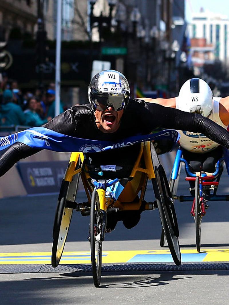 Marcel Hug of Switzerland crosses the finish line to win the men's push rim wheelchair race during the 120th Boston Marathon on April 18, 2016 in Boston.