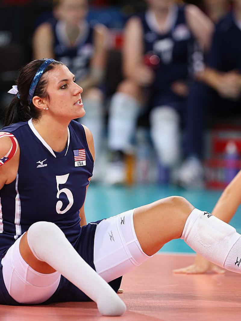 Woman sitting on a volleyball court