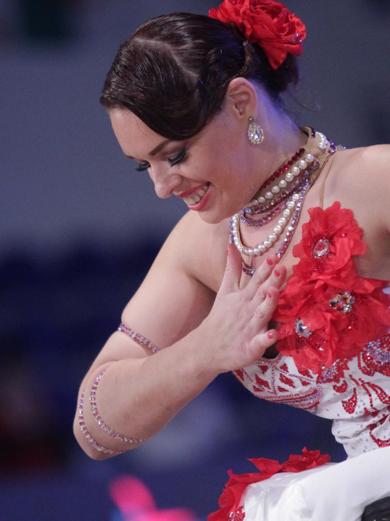 Woman wheelchair dancer bows to the audience