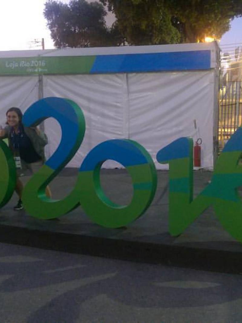 Woman posing in front of Rio 2016 sign