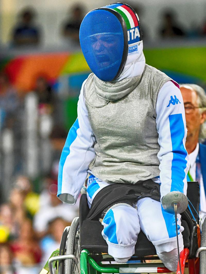 Wheelchair fencer celebrates with her mask on