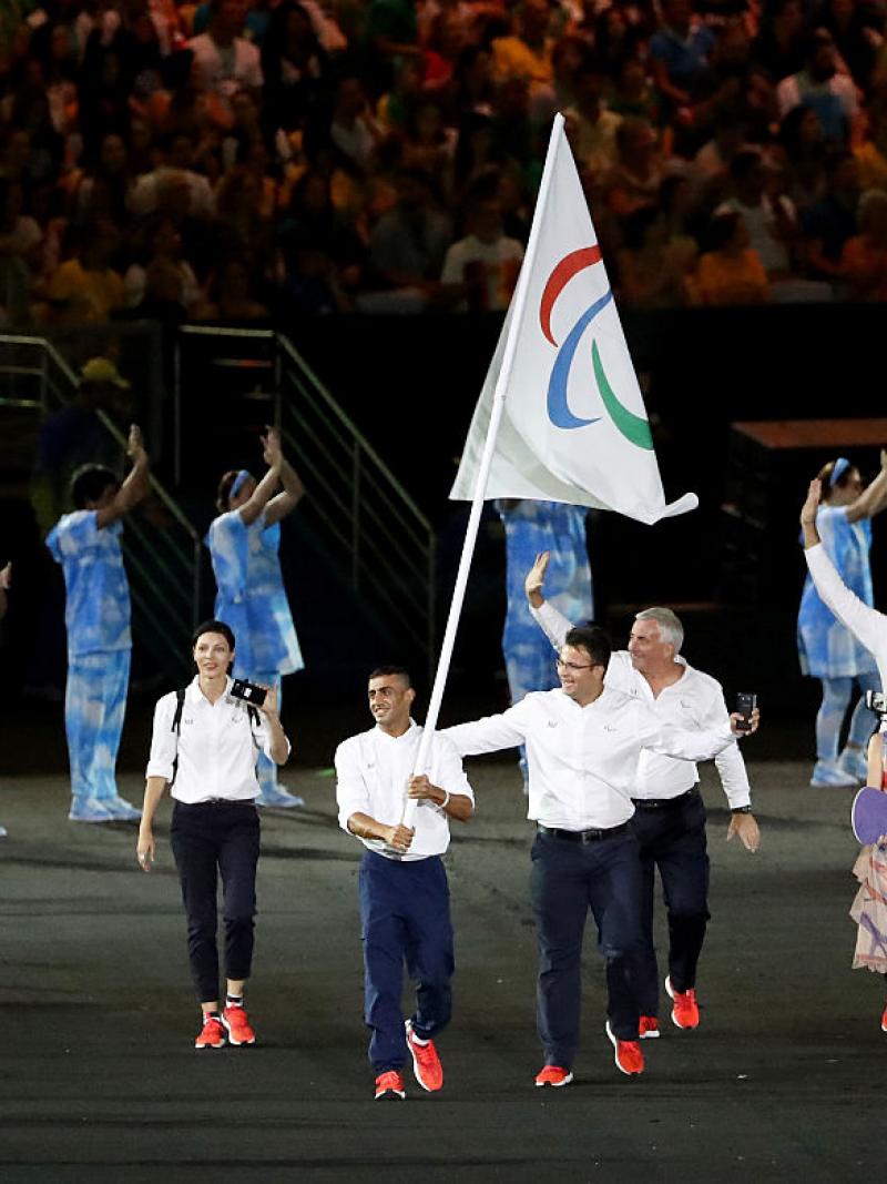 Flag bearer Ibrahim Al Hussein of Syria leads the Independent Paralympic Athletes team entering the stadium during the Opening Ceremony of the Rio 2016 Paralympic Games.