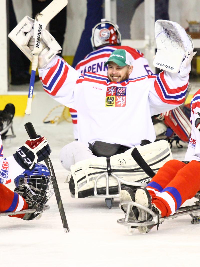 Para ice hockey players celebrate their gold medal win