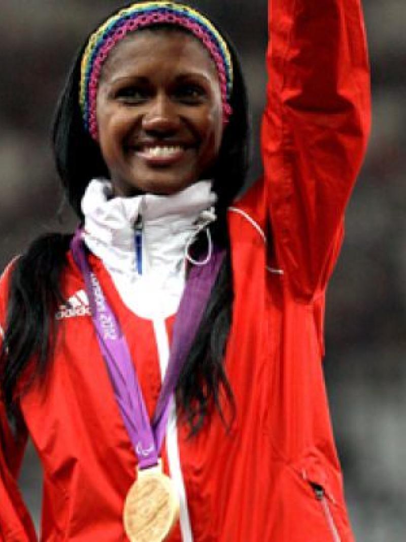 A picture of a woman showing her gold medal