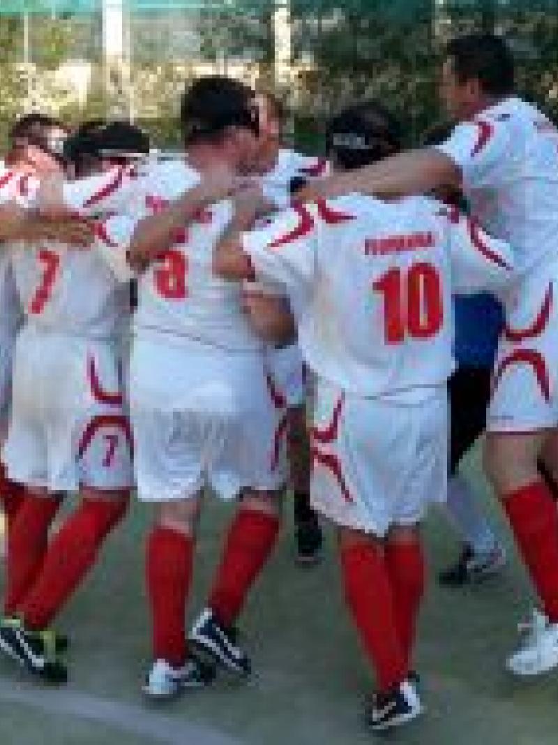 Blindfolded men in jerseys celebrating