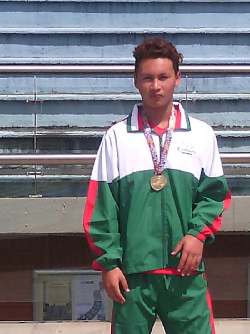 A swimmer poses with a medal