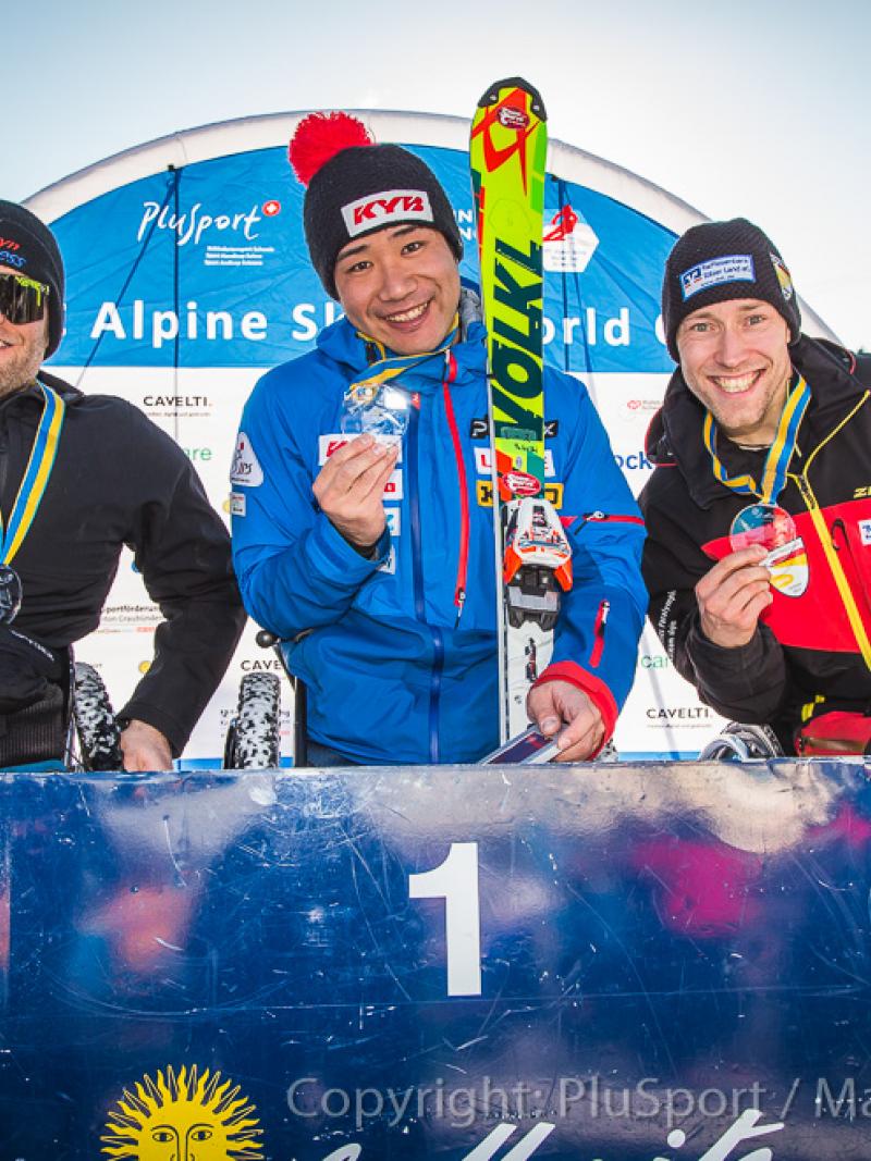 Three sit skiers hold their medals