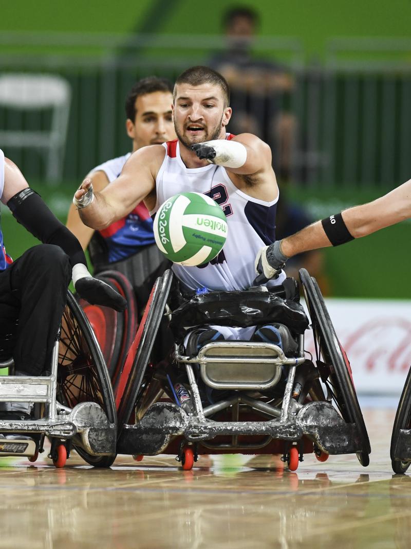 Kory Puderbaugh of United States and Christophe Salegui and Jonathan Hivernat of France compete during the Wheelchair Rugby match between United States and France
