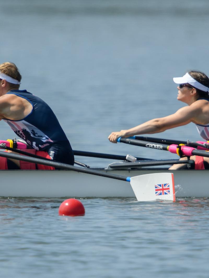 Two rowers in a boat on the water