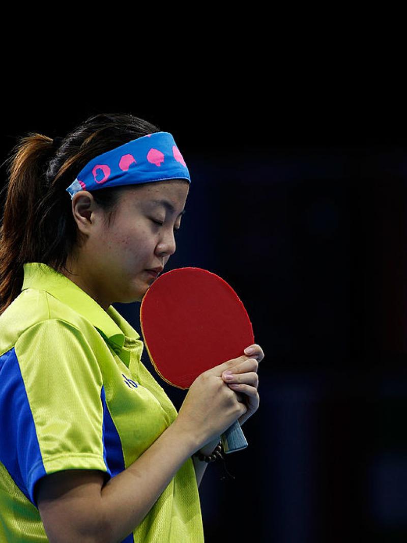 Chinese table tennis player kissing her racket.