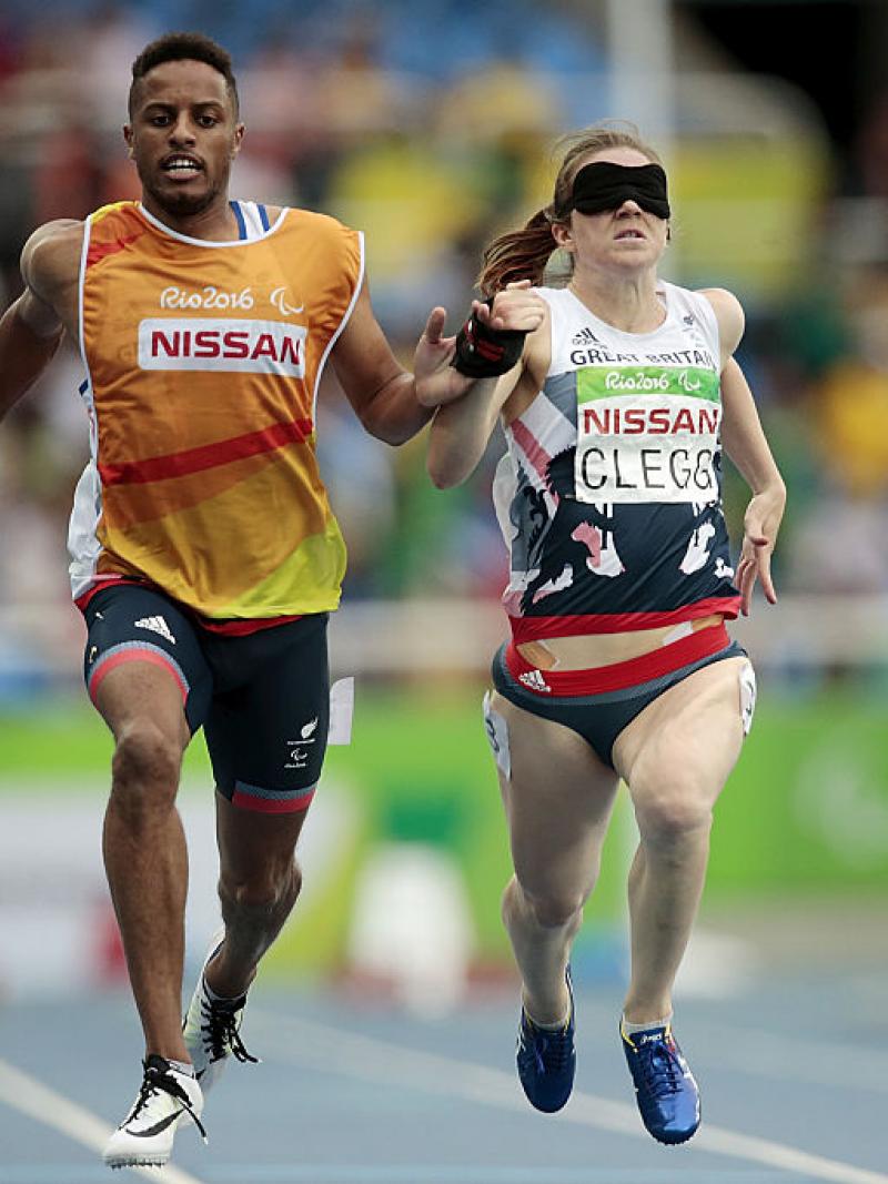 Chris Clarke and Libby Clegg of Great Britain in action during the women's 100m - T11 Semifinals at the Olympic Stadium on Day 2 of the Rio 2016 Paralympic Games