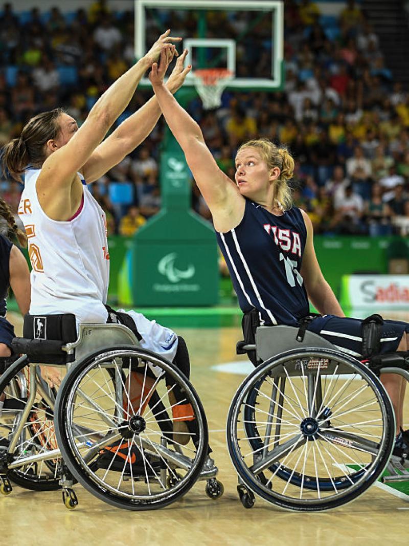 Female wheelchair basketball player Mariska Beijer fighting with another player for the ball 