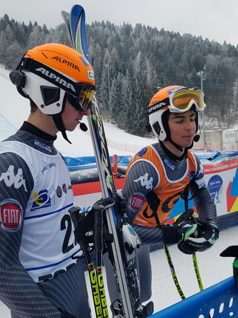 A visually impaired skier and guide in the mixed zone