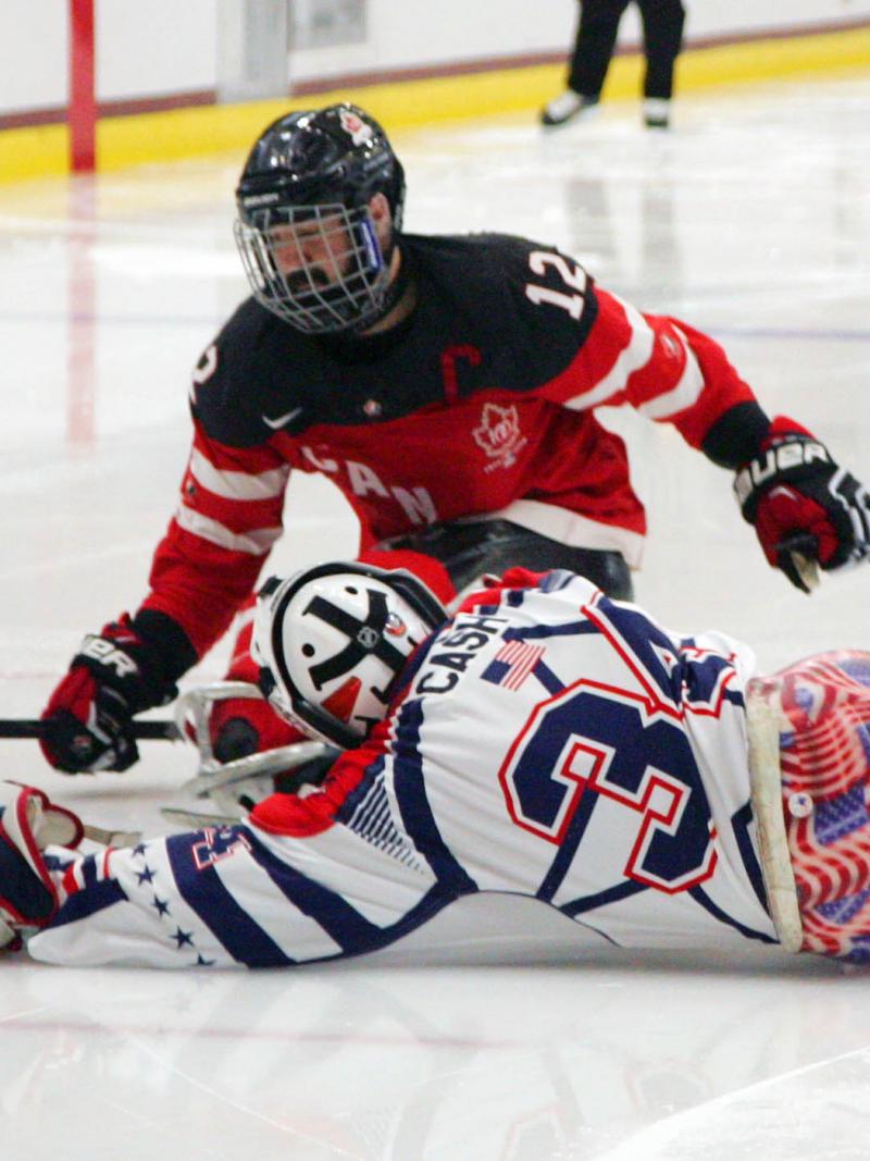 Steve Cash making a save against Greg Westlake in the gold medal game USA v Canada at the 2015 IPC Ice Sledge Hockey World Championships A-Pool in Buffalo, USA.