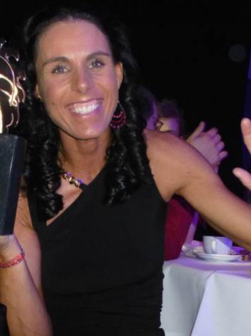 A picture of a woman showing her trophy