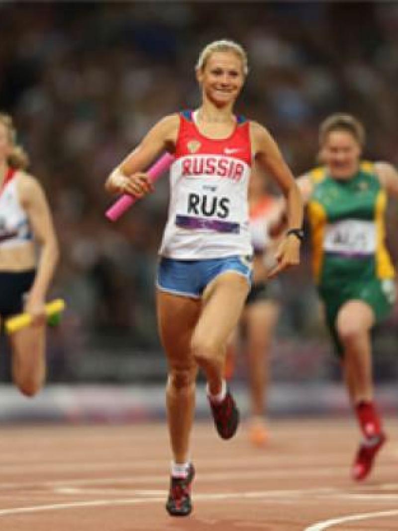 A picture of a woman running on a track