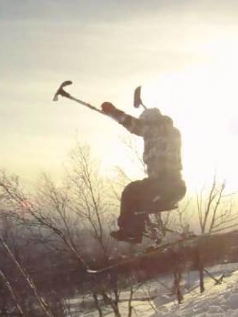 A picture of a man in a sledge skiing