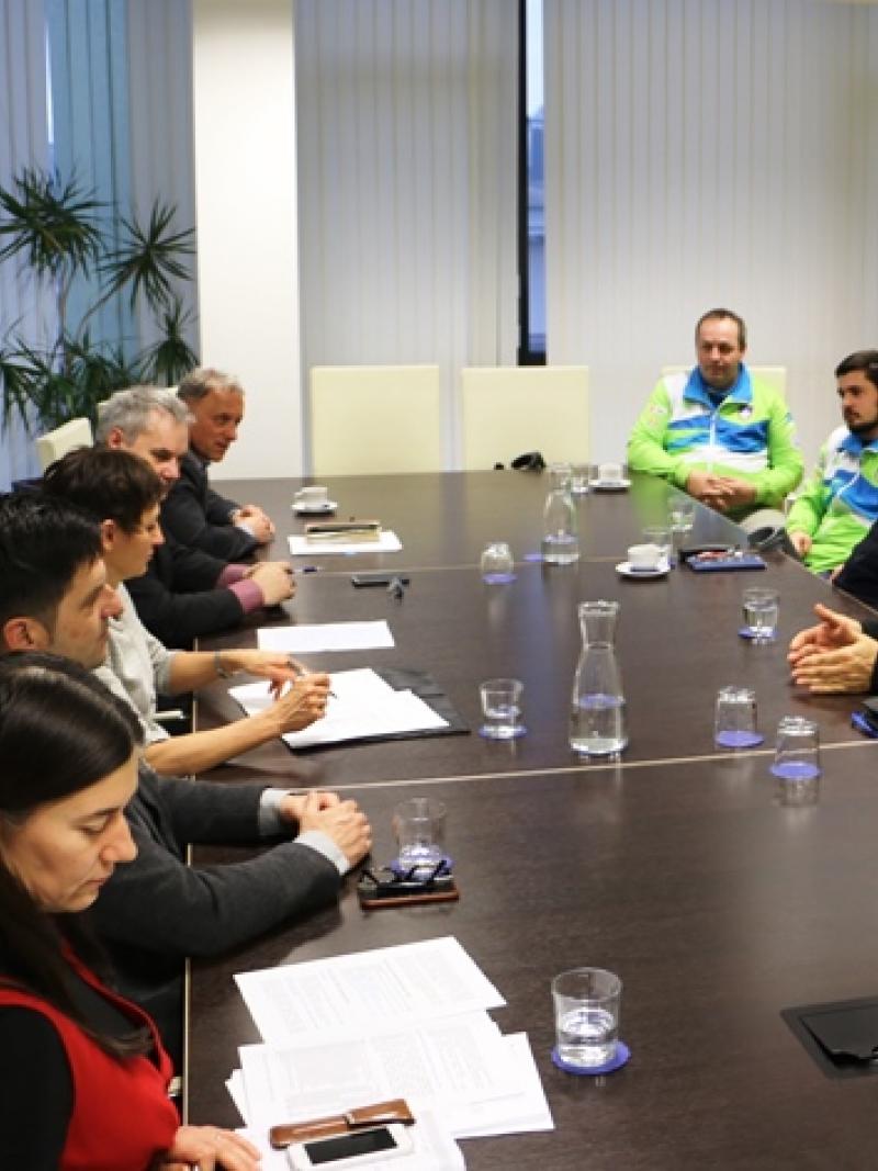People in a meeting room around the table