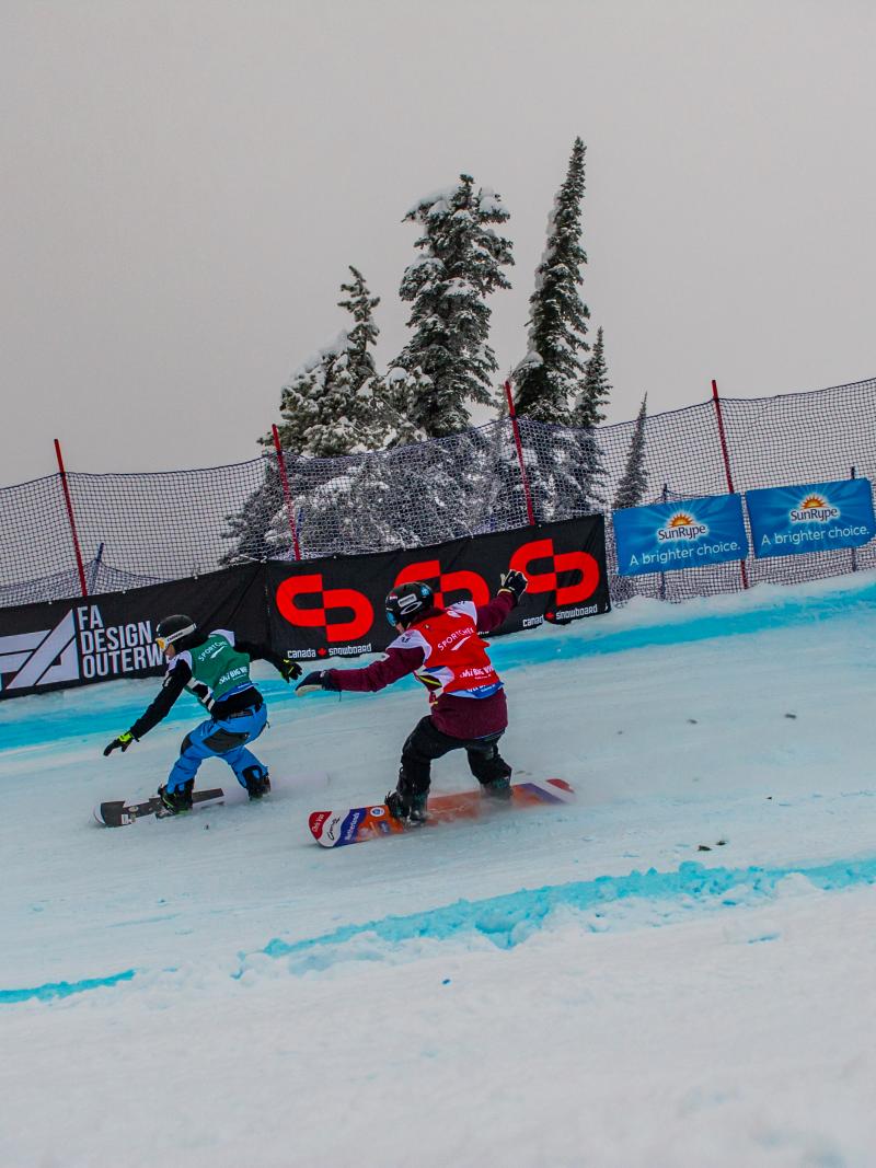 Two men on snowboards race