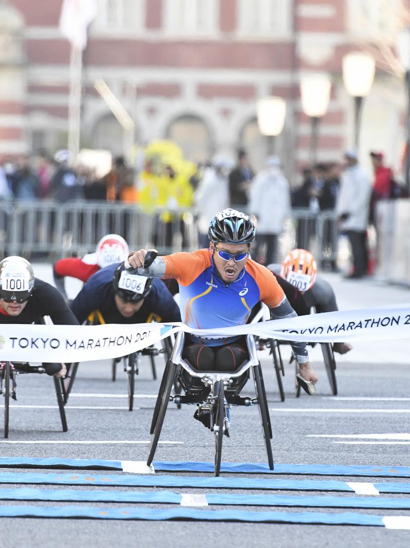 Japan's Sho Watanabe crosses the line to take the 2017 Tokyo marathon ahead of Switzerland's Marcel Hug.
