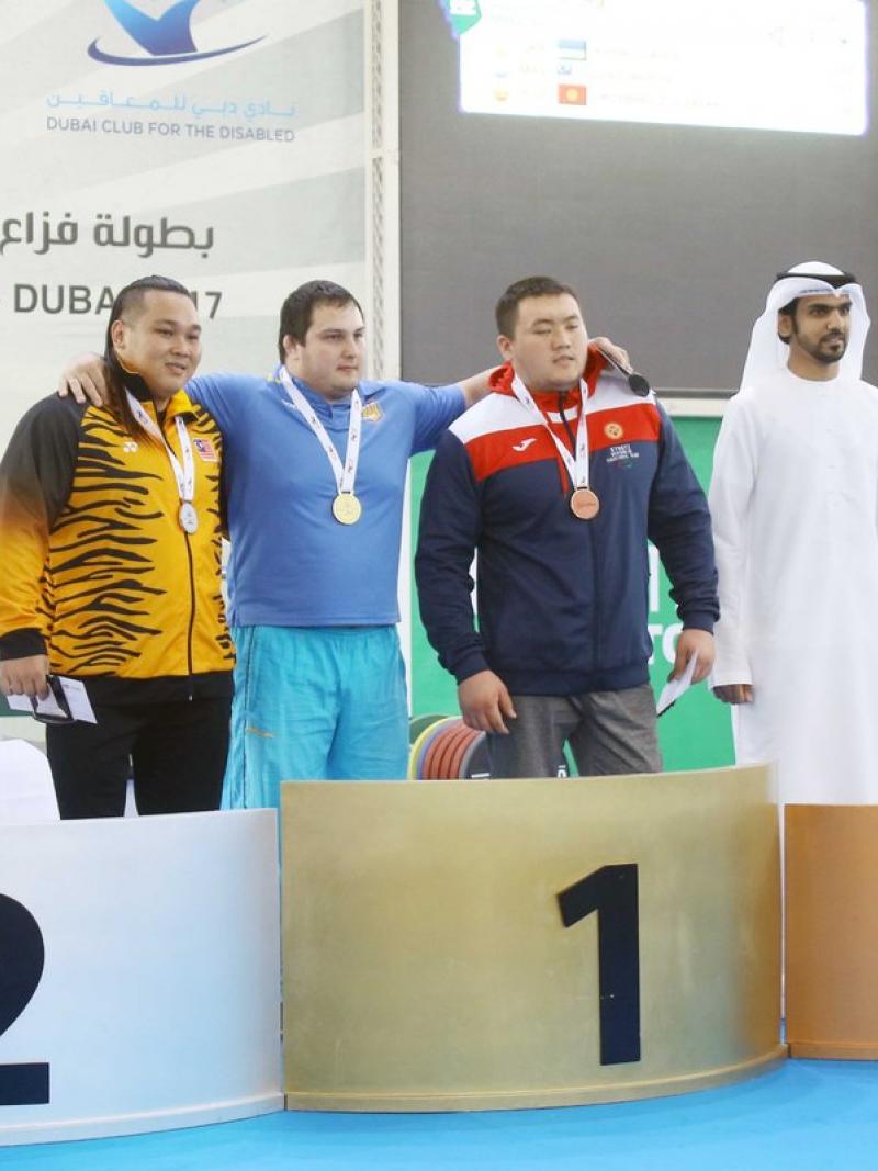 Three men on a podium