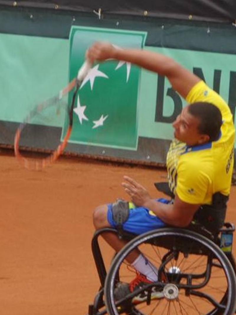 Man in wheelchair playing tennis