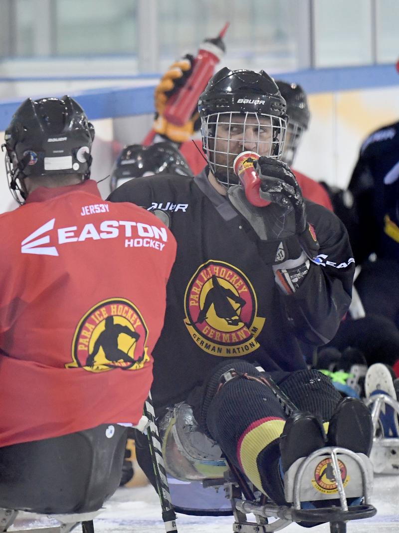 a group of Para ice hockey athletes on the ice